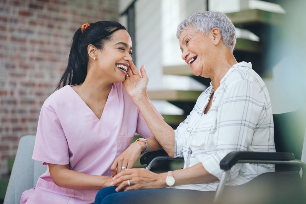 shot of a young nurse caring for an older woman in a wheelchair